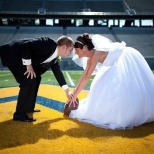Superbowl Wedding at The Views at Sunset Ridge bride & groom playing football  Showing the fun having a Chattanooga Wedding